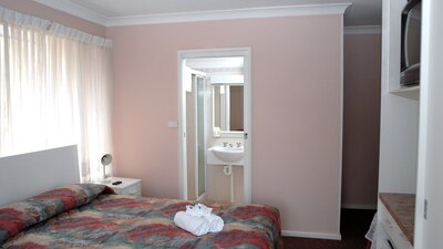 Queen size bed with view into ensuite