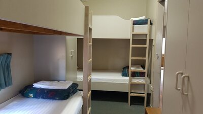 Two sets of bunks with cupboards