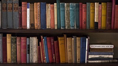 a book shelf filled with old publications