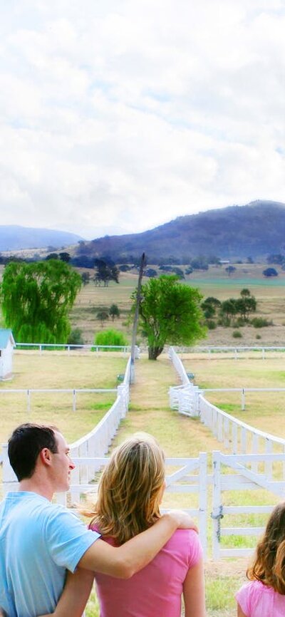 Family enjoying the country views from the veranda of the historic Lanyon Homestead near Canberra