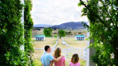 Family enjoying the country views from the veranda of the historic Lanyon Homestead near Canberra