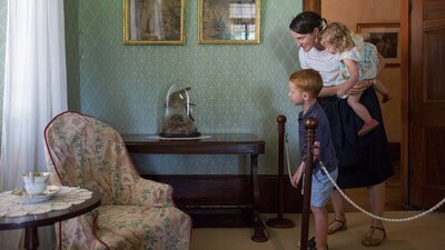 image of a mother and two children looking at furniture inside lanyon homestead