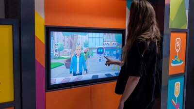 Woman playing touchscreen game in DemocraCity