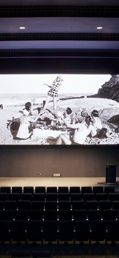 Arc Cinema with archival black and white footage on the screen