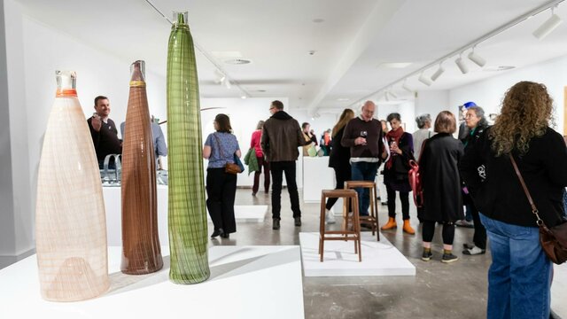 2024 ANNUAL MEMBERS EXHIBITION People walking around in a gallery.