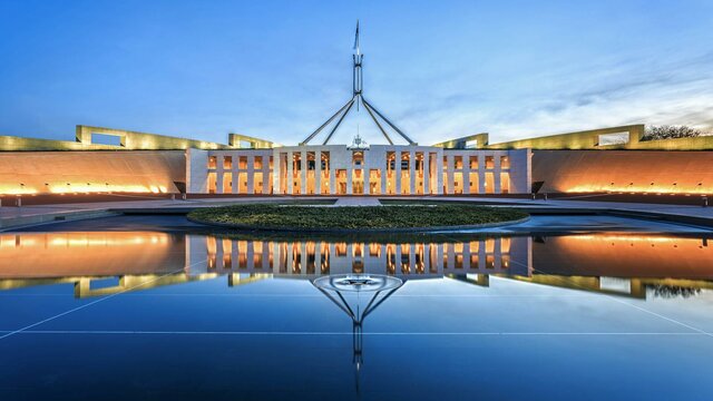 Launch of the new Parliamentary Handbook Website Photo of Australian Parliament House in the evening.