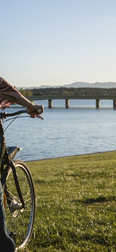 Girl on a Share A Bike bike at the lake