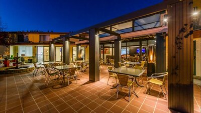 Back Deck lit at night and set with tables and chairs