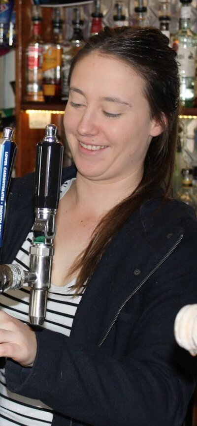 Girl pouring a beer at the bar