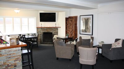 Lounge bar with comfortable seating, fireplace and television
