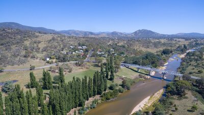 aerial photo of the Murrumbidgee river with the Tharwa Bridge crossing it