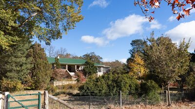 view of a heritage listed homestead amidst an autumnal garden