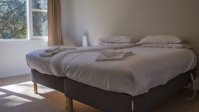 two beds inside the Pisa cottage at Cuppacumbalong