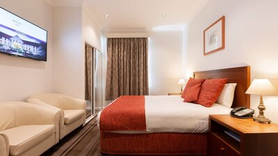 Hotel Room with Queen Bed, Armchairs and TV