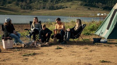 Family sitting around a fire place for lunch.