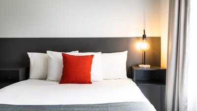 Modern styling and comfortable bedding at River Motel.