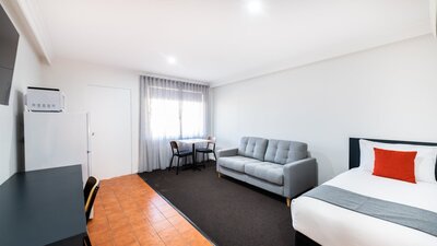 Spacious living area in River Motel's Family Suite, including extra single bed and sofa bed.