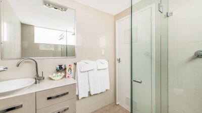 Modern bathroom amenities with linen and towels provided at River Motel.