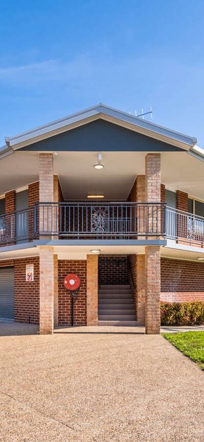 River Motel Suites' historic exterior, with undercover garage parking under each suite.