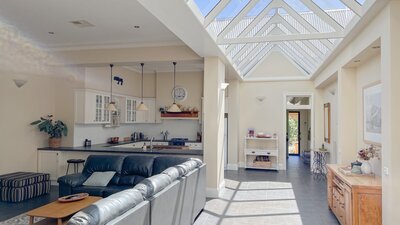 Large living area with a glass atrium roof