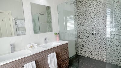 Bathroom with shower and two sinks