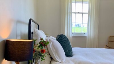 Charming lamps and beautiful Australian artwork feature in this bedroom.