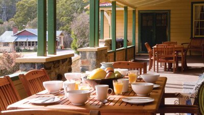 Breakfast on the verandah at Yarrangobilly Caves House 1901 section, Kosciuszko National Park.