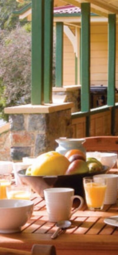 Breakfast on the verandah at Yarrangobilly Caves House 1901 section, Kosciuszko National Park.