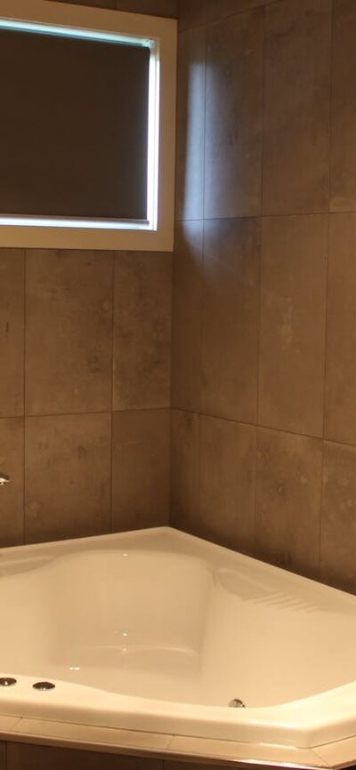 Main bathroom with spa bath Corner spa bath in main bathroom