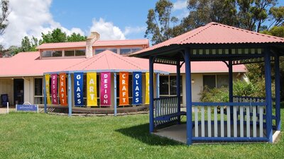 Art, Design, Craft and Glass banners at the entrance to Aboriginal Dreamings Gallery