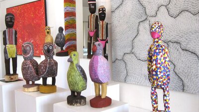 Large carved birds and ceremonial figures by Utopia artists, Aboriginal art paintings.