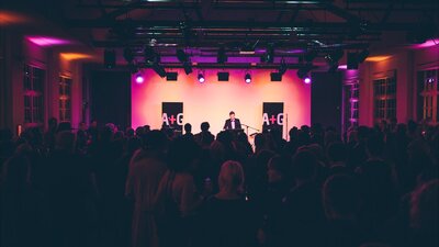 An event in the Main Hall at the Ainslie Arts Centre. Large crowd of people turned towards the stage