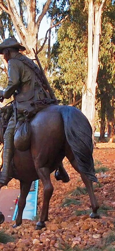 Bronze Men on horeseback emerge from the bush and cascade down the hill