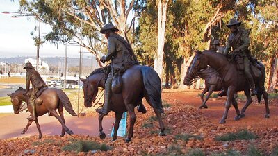 Bronze Men on horeseback emerge from the bush and cascade down the hill