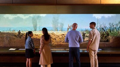 A group of people looking at the Dernancourt Diorama at the Australian War Memorial