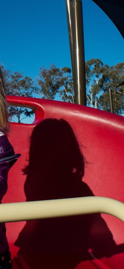 Girl on a spinning piece of play equipment in the Boundless Playground