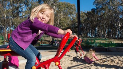 Girls playing in the sand at the Boundless Playground