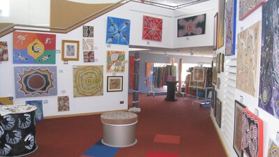 Artwork on display on the walls to the right of the staircase