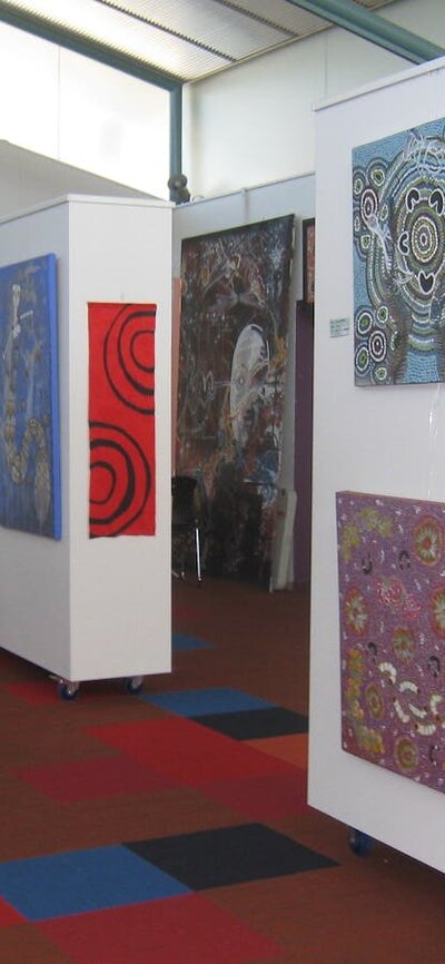 Burrunju Art Gallery Artwork displayed on movable walls near the rear of the gallery