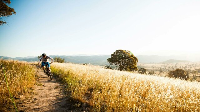 Enjoy the wide open spaces and fresh air Lone cyclist in the wide open spaces