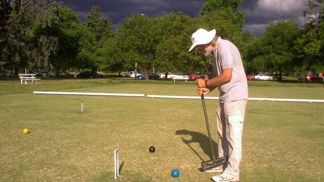 Croquet Gentleman at practice on a stormy day