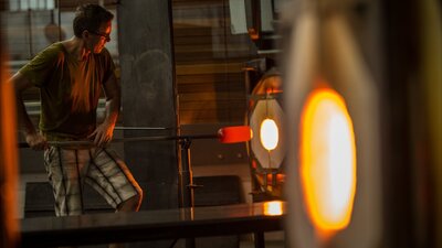 Man making glass object