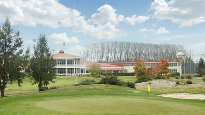 Wide view of Canberra International Golf Centre in the background and course in the foreground