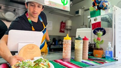 Man serving tacos from food truck