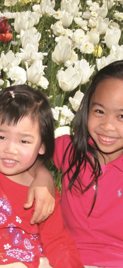 Children posing with the tulips at Floriade