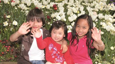 Children posing with the tulips at Floriade