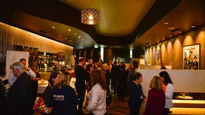 Patrons gather in the premium lounge bar before a movie