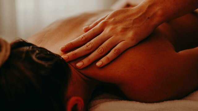 Renew Spa Package Woman receiving shoulder massage in spa