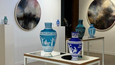 Glass amphoras and lancscape paintings