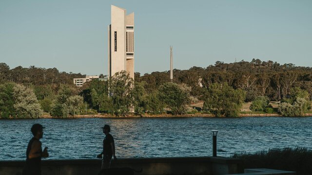 A body of lake with monuments in the background